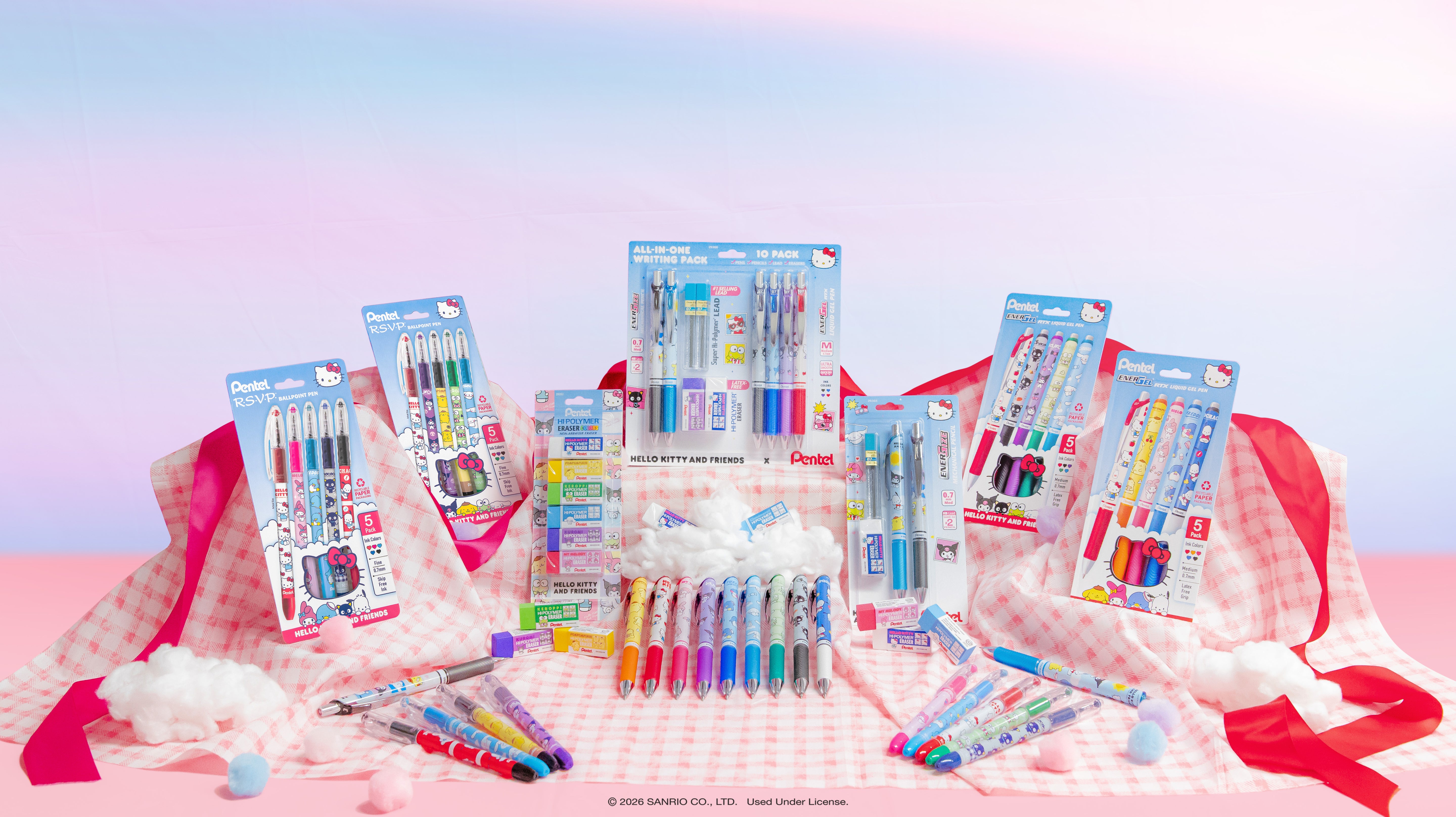 Assorted stationery items including pens and markers on a checkered tablecloth with a pastel background.
