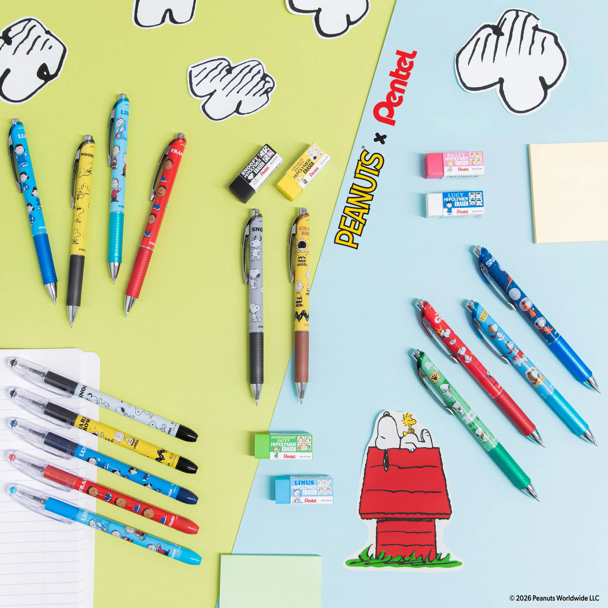 Flat lay of colorful pens and stationery arranged on green and blue backgrounds with Peanuts character illustrations and playful black and white doodles