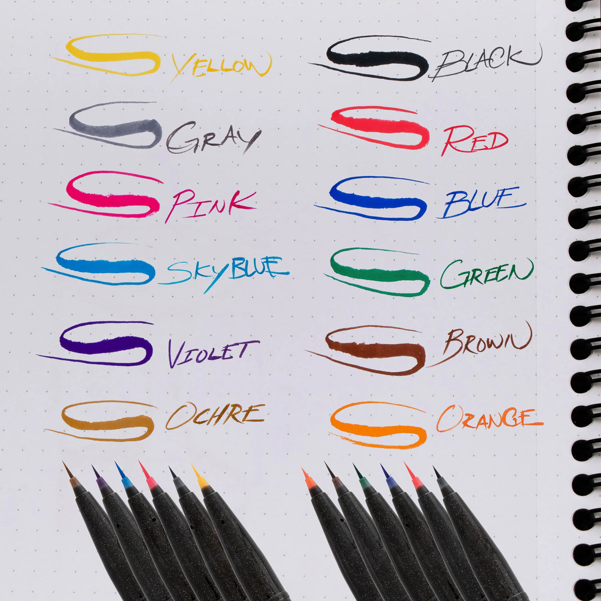 Colored micro brush pens displayed with vivid ink swatches labeled yellow black gray red pink blue sky blue green violet brown ochre and orange for detailed art supplies