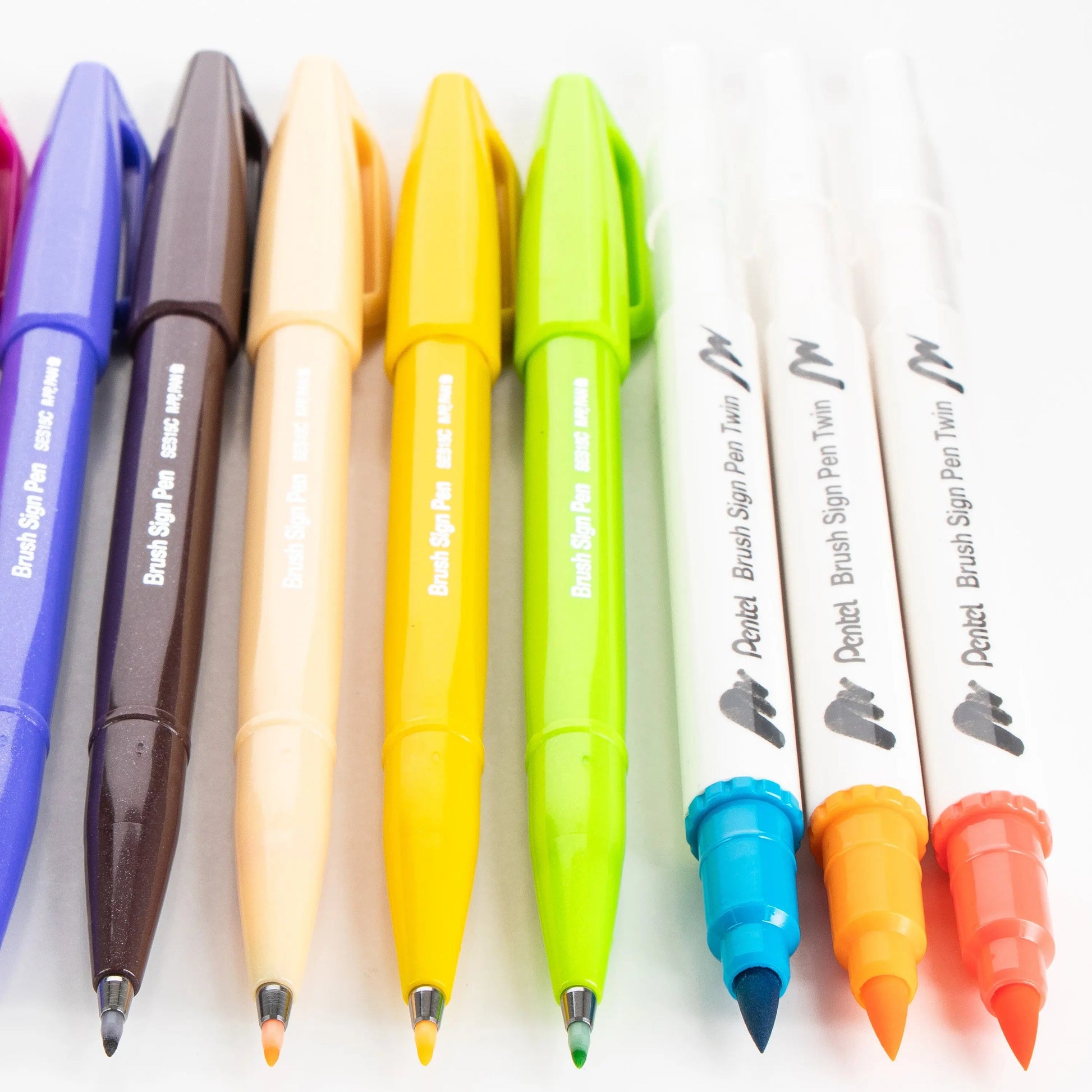 Colorful assortment of pens including ballpoint and brush sign pens in various bright shades, ideal for creative journaling and art projects with premium quality.