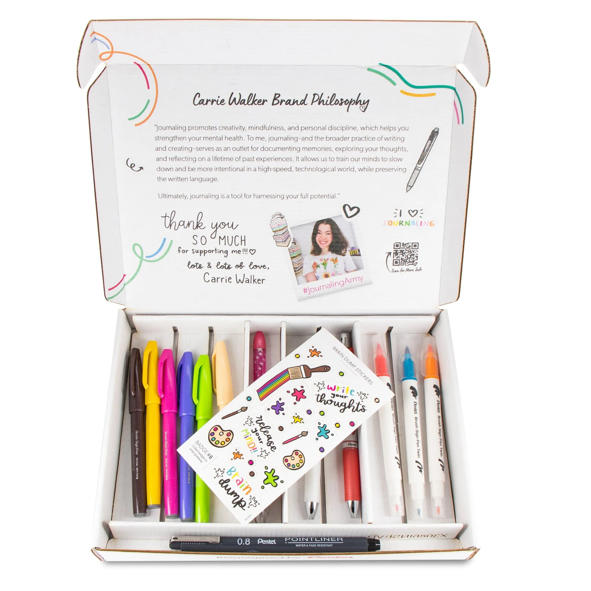 Open box showing a colorful set of quality gel pens and markers with a card and inspirational journaling message inside a neatly organized Brain Dump Journaling Pack.